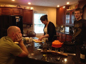 Faith making Chicken Alfredo from scratch while Richard takes notes.
